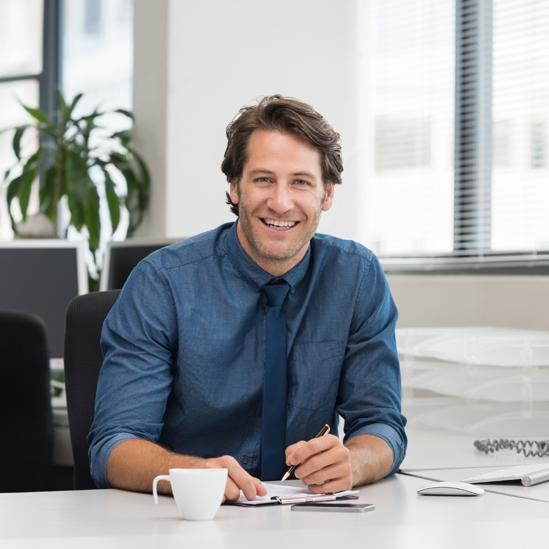 business-man-sitting-at-desk-with-pen-and-papers