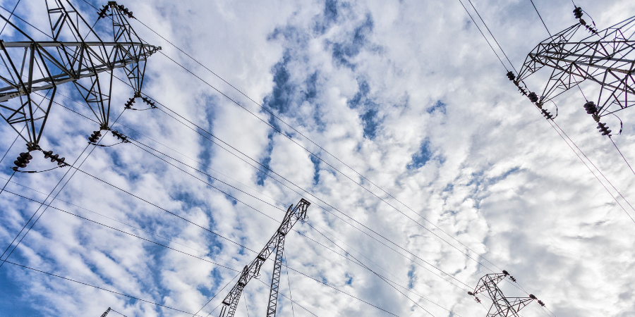 electrical-power-lines-against-cloud-filled-sky
