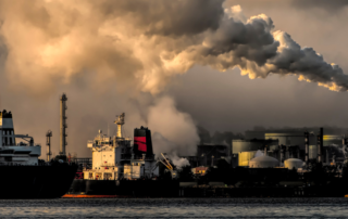 carbon-emissions-coming-from-manufacturing-plant-near-harbor