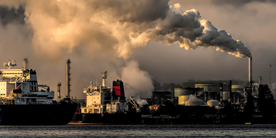 carbon-emissions-coming-from-manufacturing-plant-near-harbor