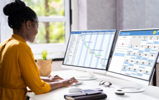 woman-looking-at-calendar-and-schedule-on-computer-screens