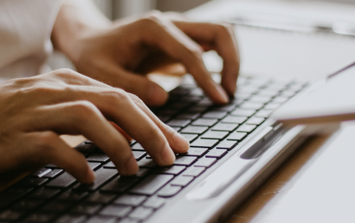 womans-fingers-typing-on-keyboard