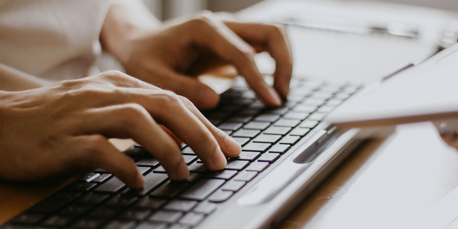 womans-fingers-typing-on-keyboard