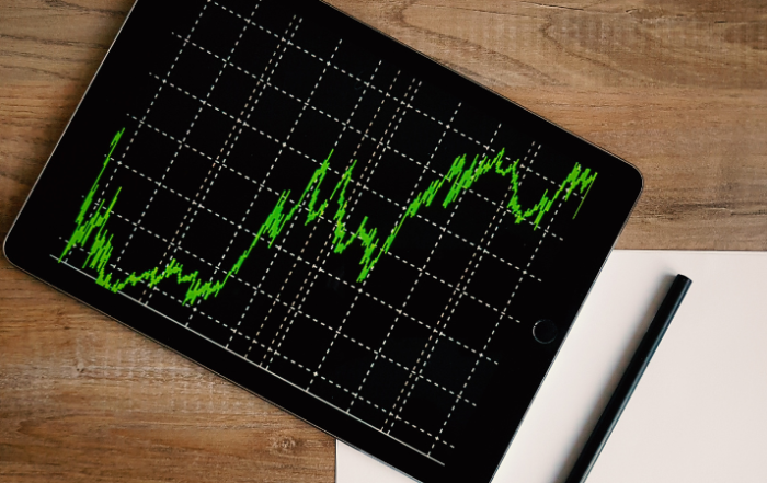 ipad-with-market-chart-that-is-spiking-upward