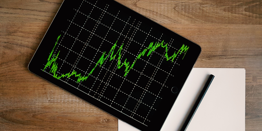 ipad-with-market-chart-that-is-spiking-upward