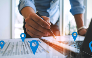 multiple-location-concept-with-pins-overlayed-on-worksheet-and-laptop