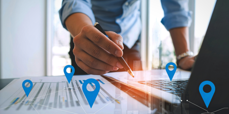 multiple-location-concept-with-pins-overlayed-on-worksheet-and-laptop